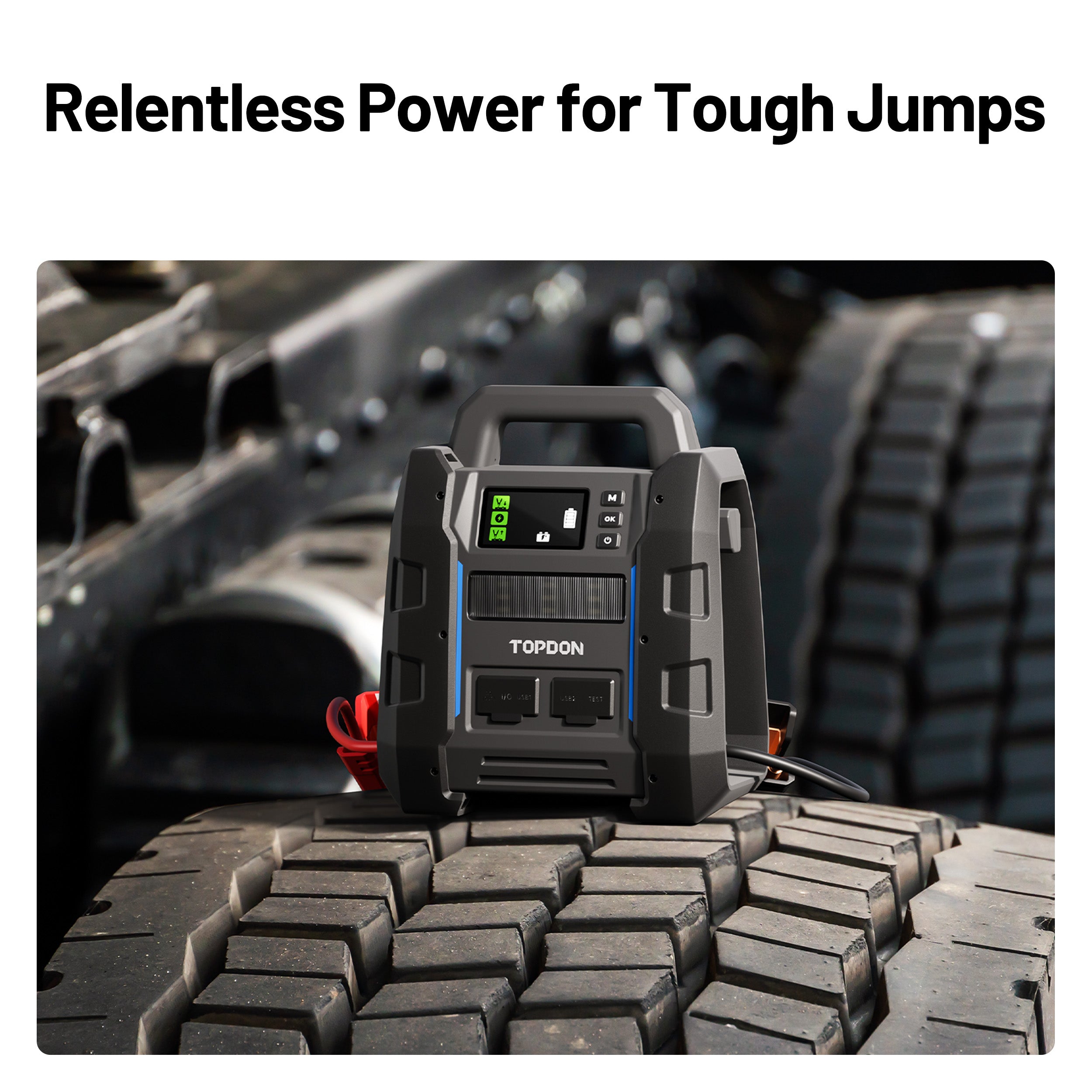 TOPDON V4500 Plus jump starter resting on a heavy vehicle tire